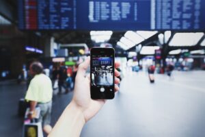 Person Holding Iphone in Airport