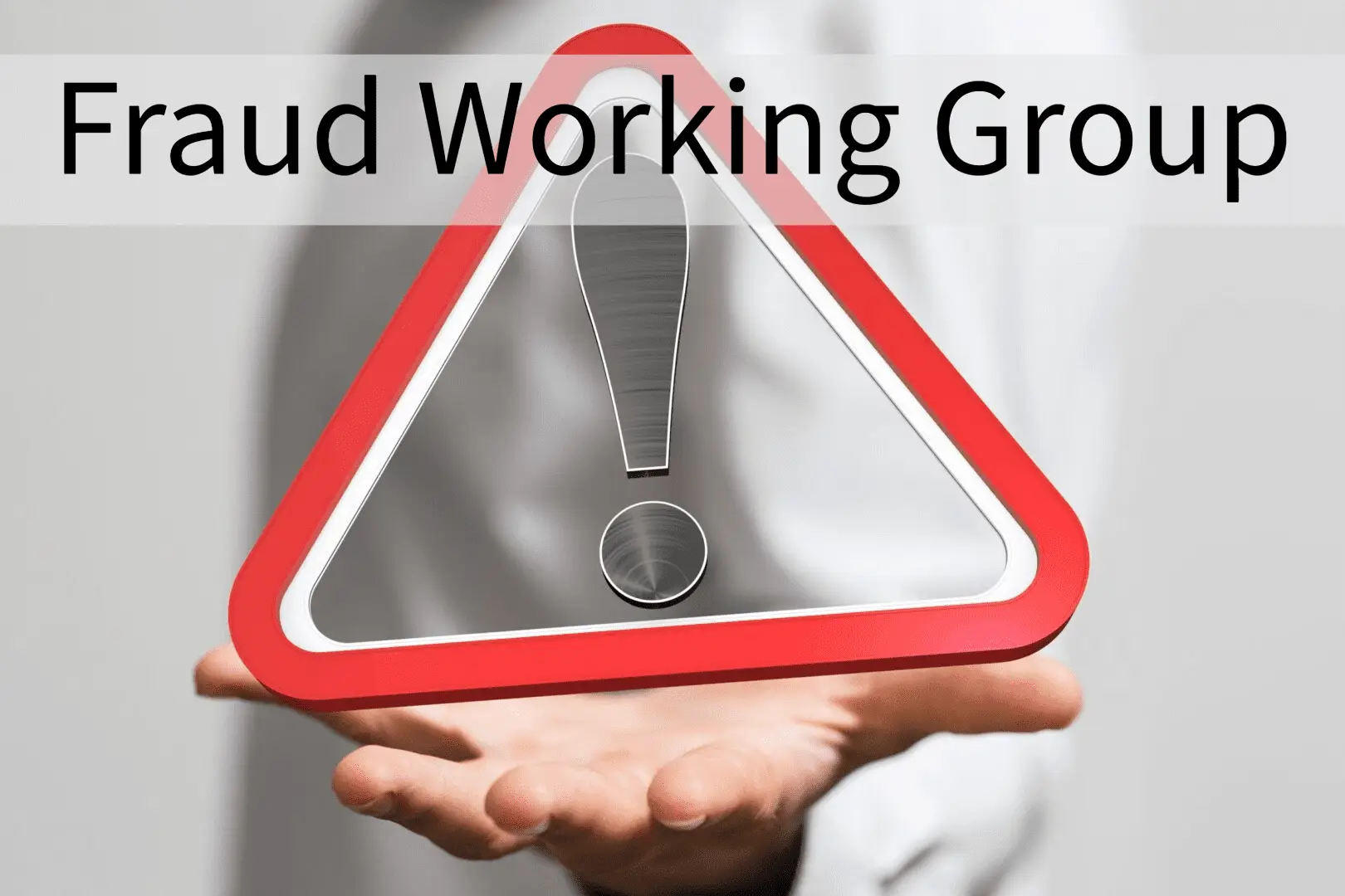 Hand holding a warning sign with "Fraud Working Group" text.