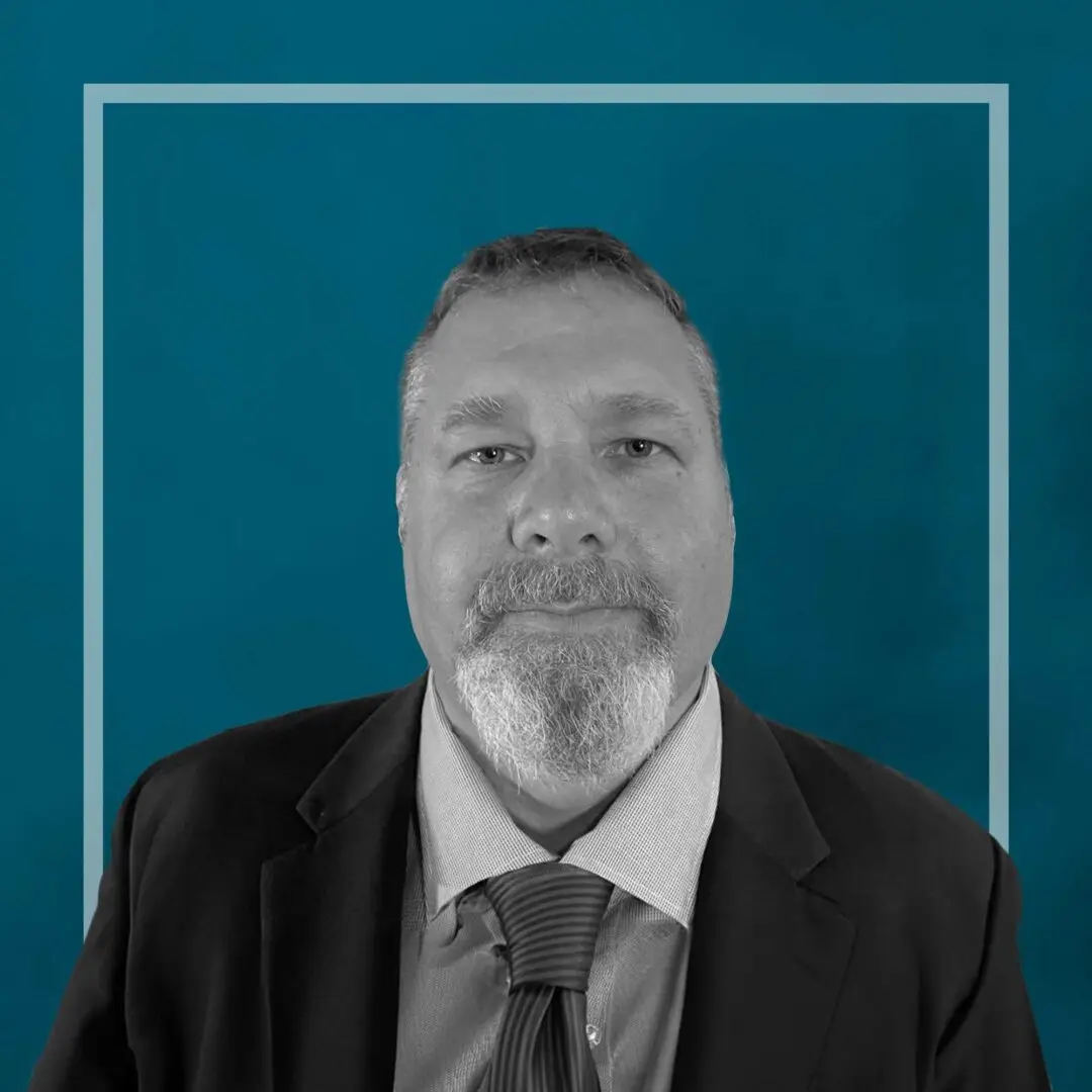 Black and white portrait of a man in a suit.