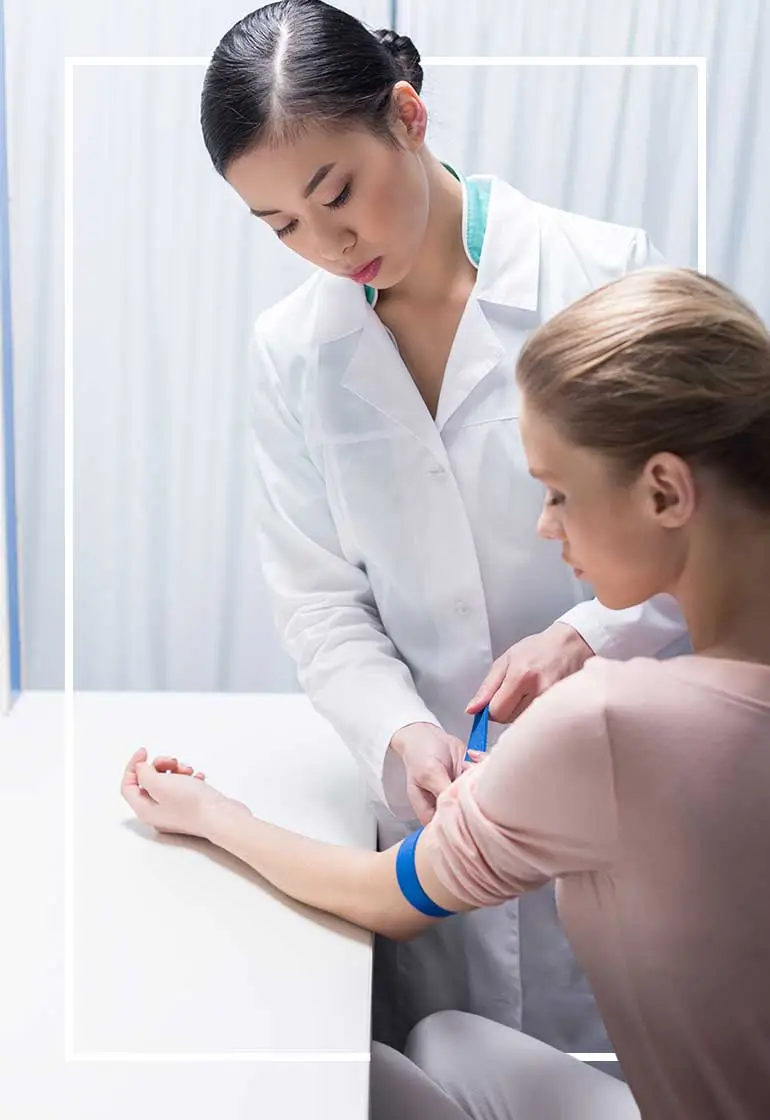 Doctor taking patient's blood sample.