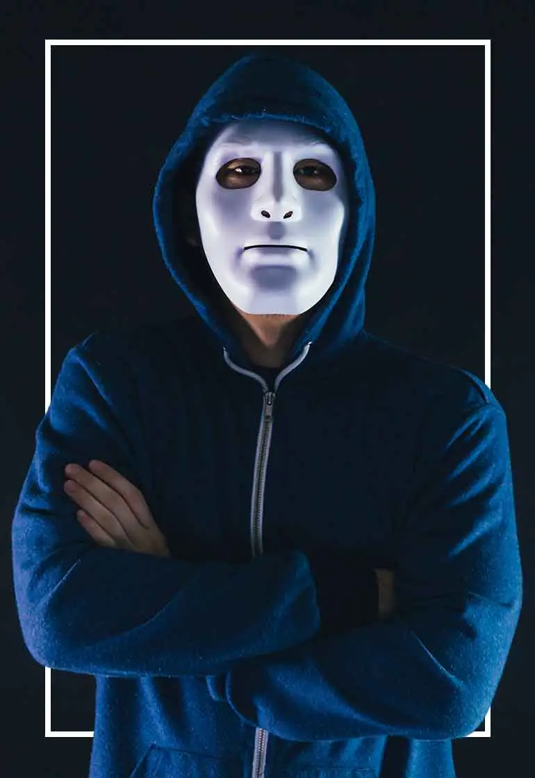 Masked person in a blue hoodie.
