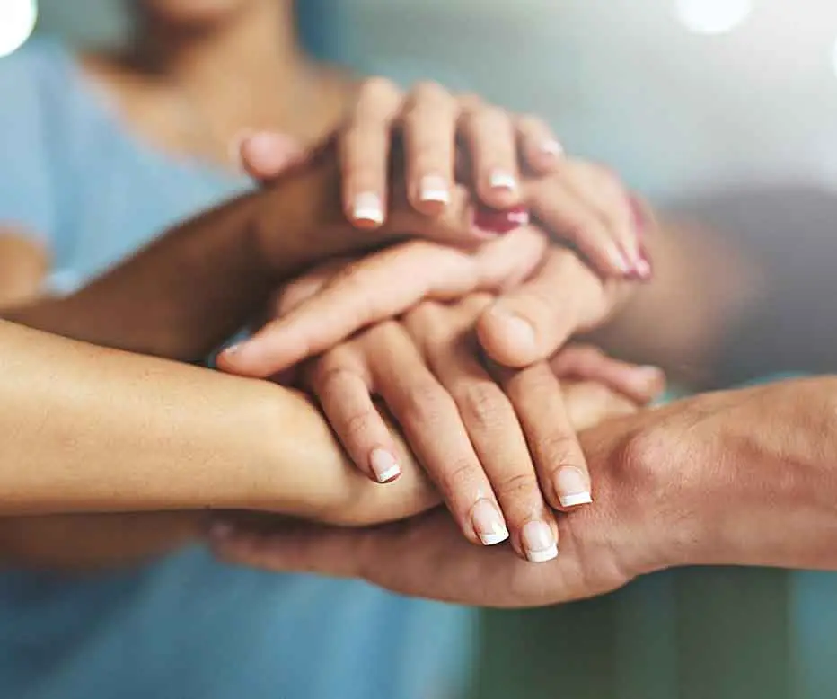 Hands clasped together in unity.