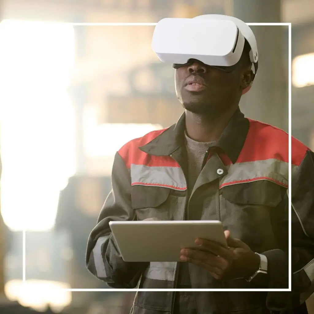 Worker using VR headset and tablet.