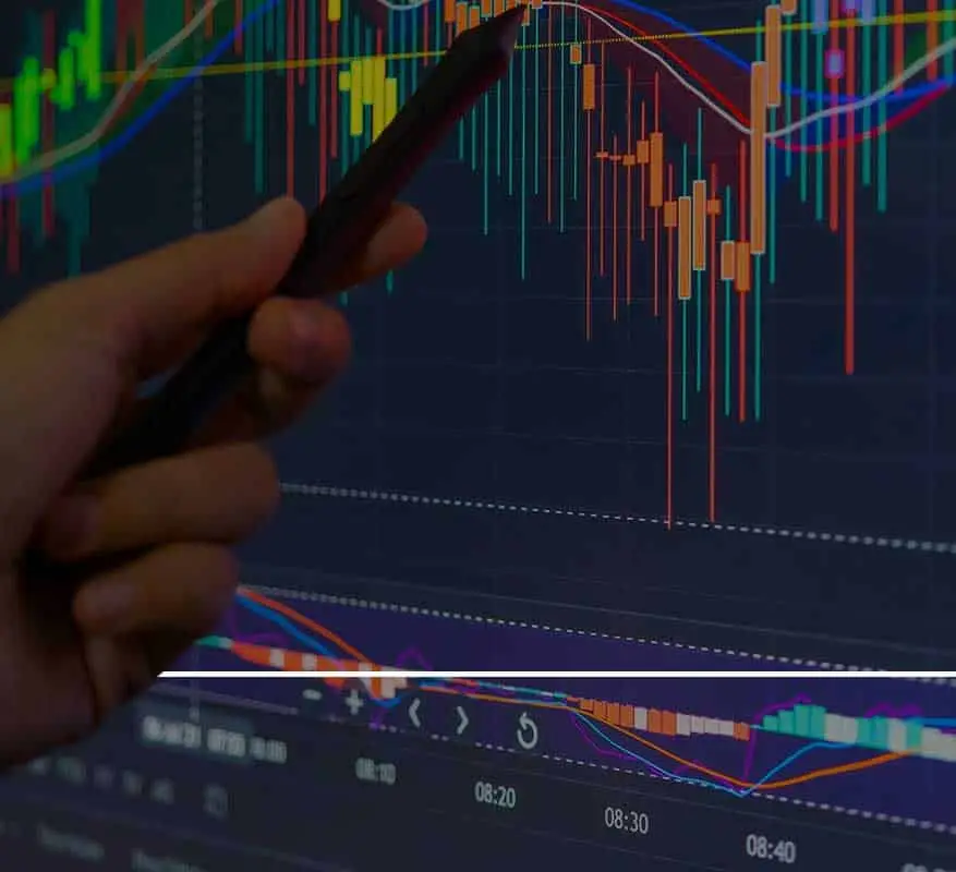 Hand pointing at stock market chart.