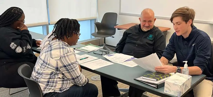 Group reviewing documents at a table.