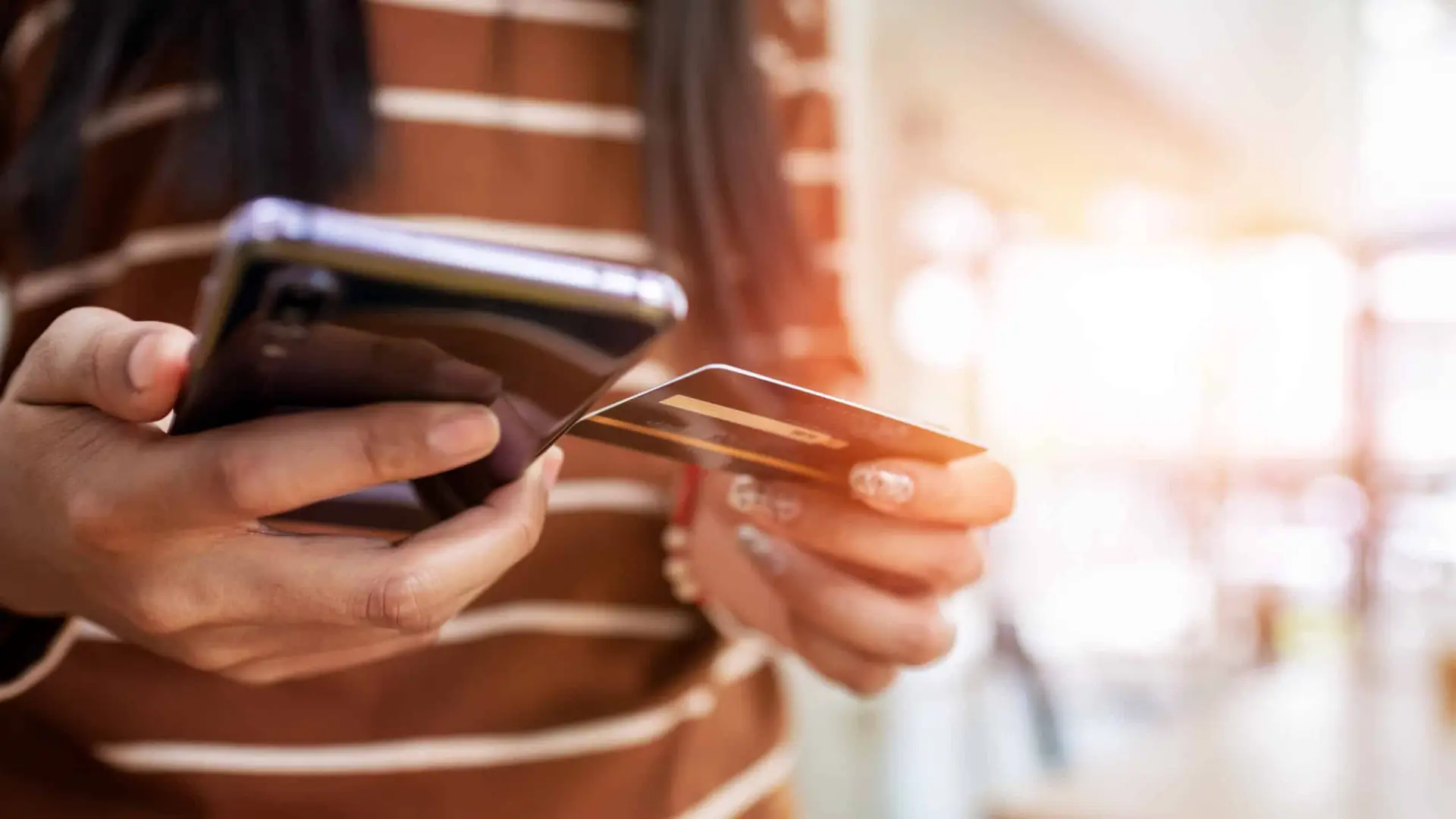 Person using phone for mobile payment.